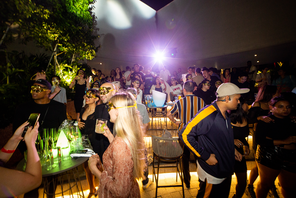 Guests at a night-time party event at 1-Arden