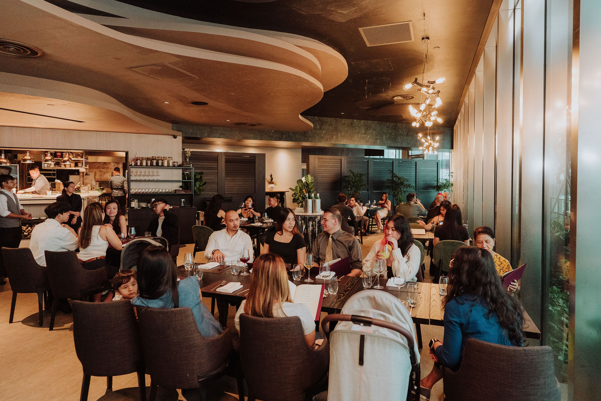 Guests at a corporate dinner in a 1-Arden dining room at CapitaSpring