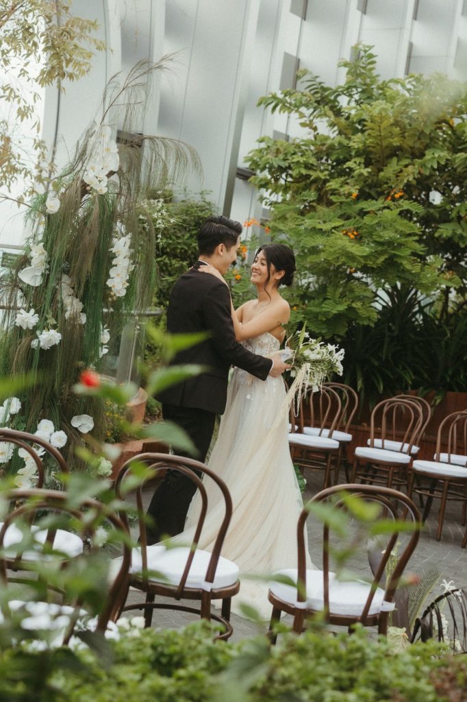 Bride and groom embracing at a garden solemnisation in the 1-Arden sky garden, Singapore