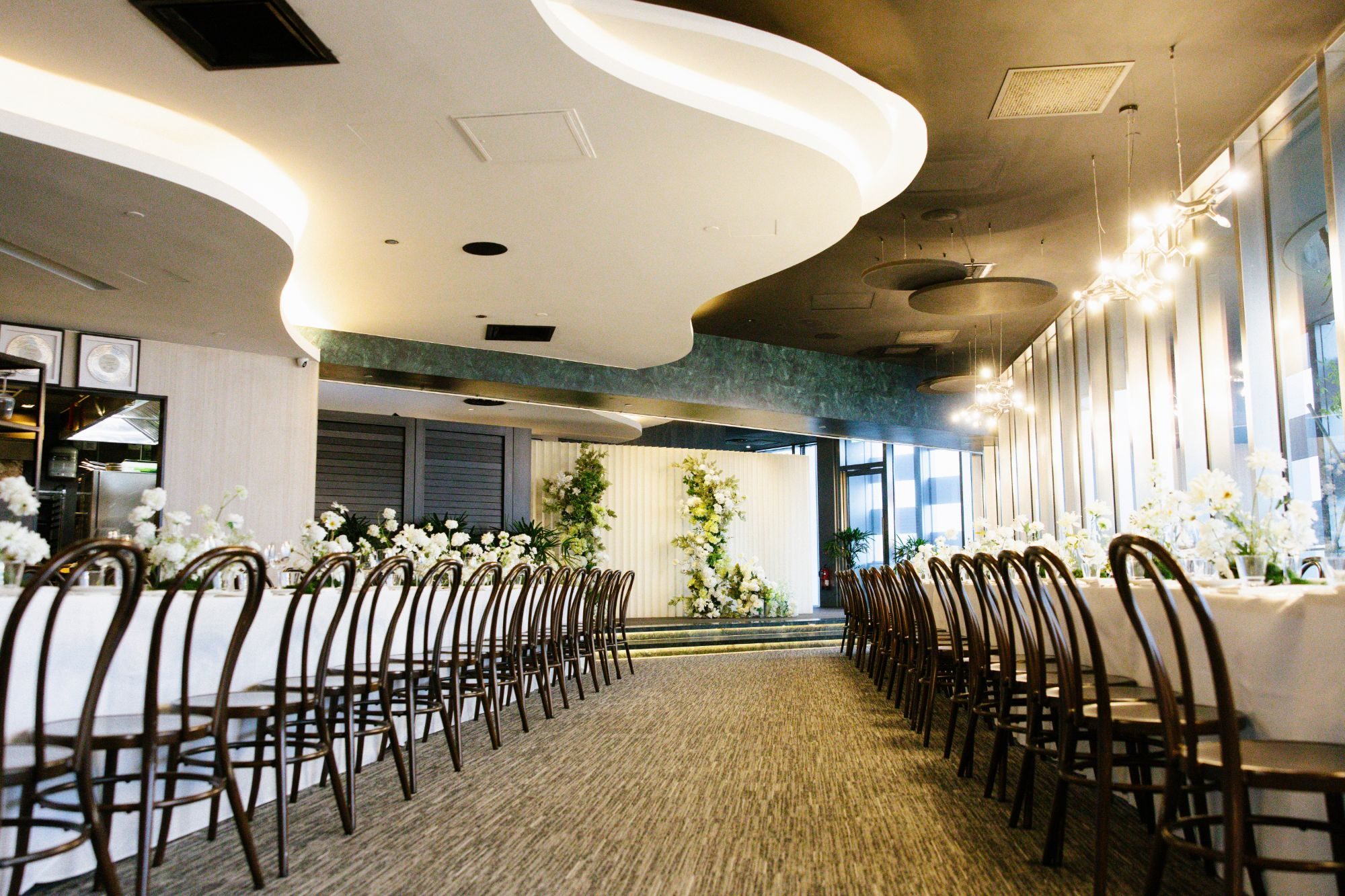 1-Arden wedding banquet with long tables, white florals and a floral stage backdrop